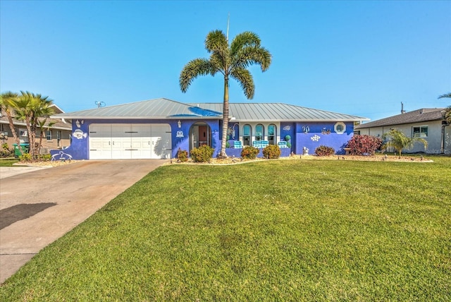 single story home featuring driveway, metal roof, an attached garage, a front yard, and stucco siding