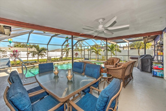 view of patio with glass enclosure, a fenced backyard, a ceiling fan, and area for grilling