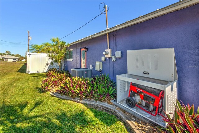 1413 SE 36th St, Cape Coral, FL 33904 - view of side of property featuring a yard, central air condition unit, and stucco siding