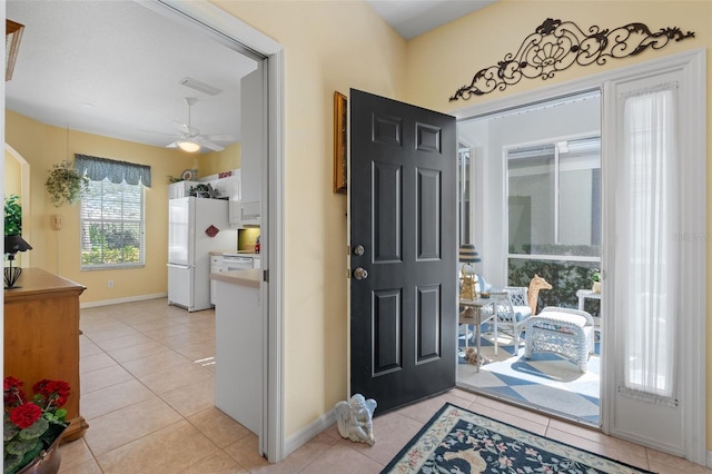 tiled entrance foyer featuring ceiling fan