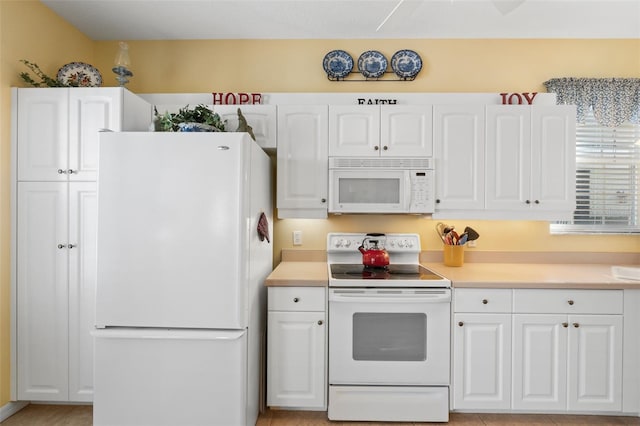 kitchen with white cabinets and white appliances