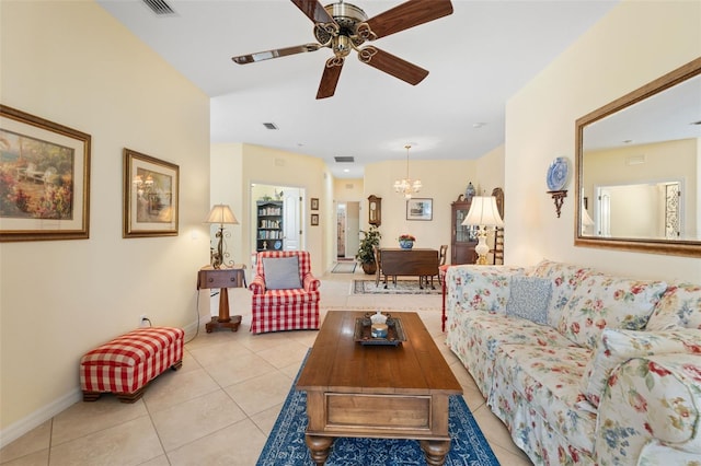 tiled living room featuring ceiling fan with notable chandelier