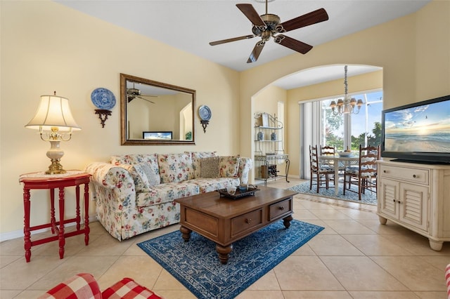 tiled living room featuring ceiling fan with notable chandelier