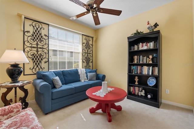 carpeted living room with ceiling fan