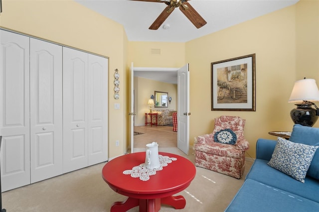 interior space with light colored carpet and ceiling fan