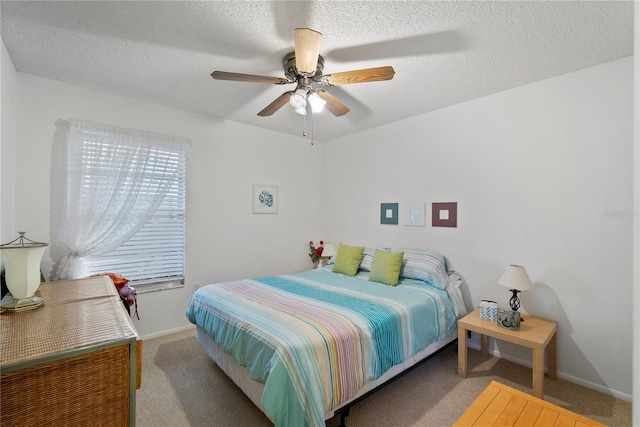 carpeted bedroom with ceiling fan and a textured ceiling