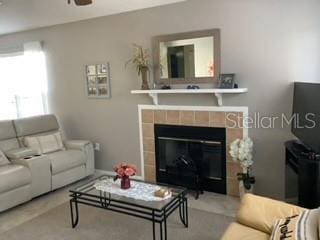 living room with a tile fireplace