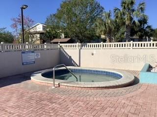 view of swimming pool featuring a community hot tub