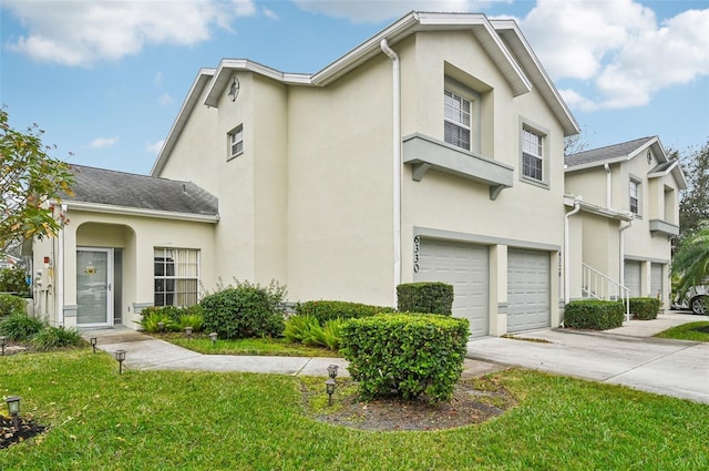 view of front of home with a garage and a front lawn