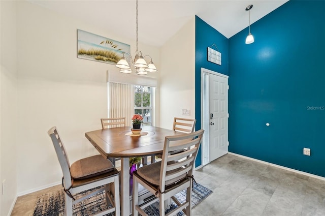 dining space with an inviting chandelier and high vaulted ceiling