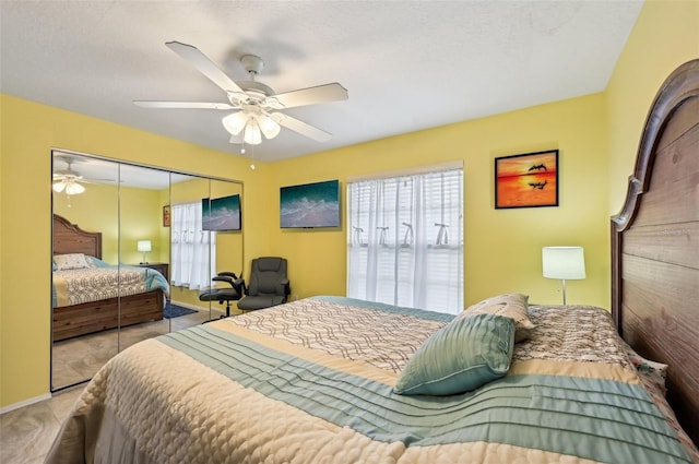 bedroom featuring multiple windows, a closet, and ceiling fan