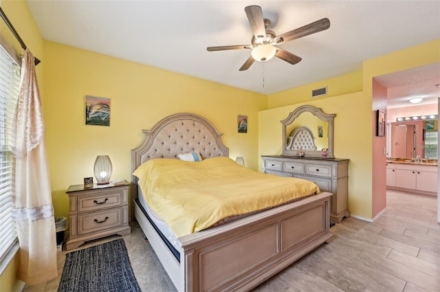 bedroom with ensuite bathroom and ceiling fan