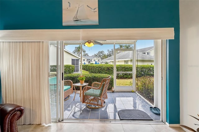 doorway featuring ceiling fan