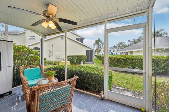 sunroom featuring plenty of natural light and ceiling fan