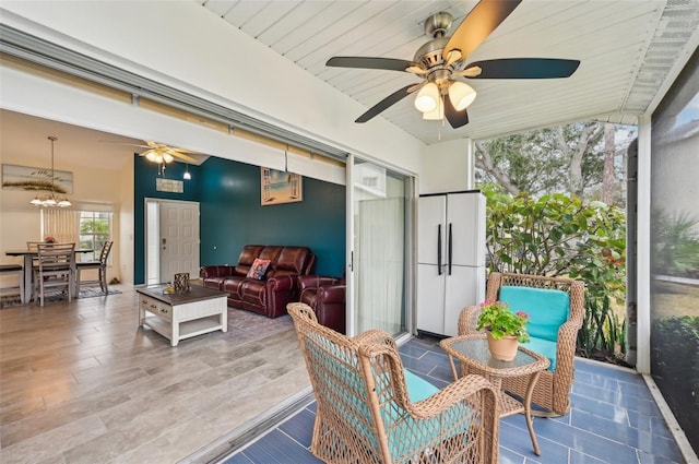 sunroom featuring ceiling fan