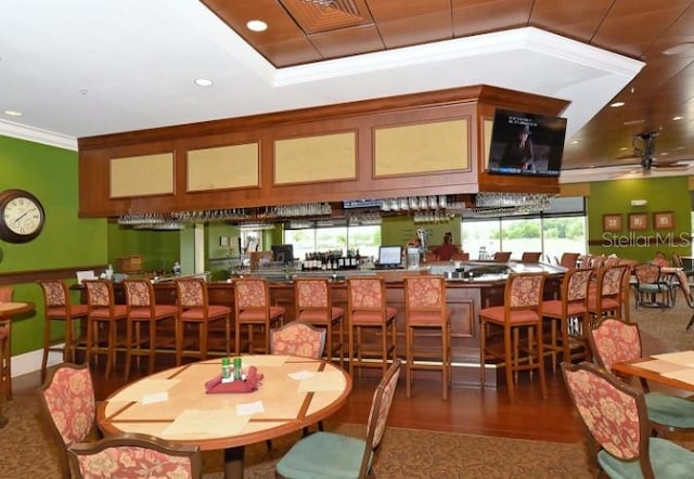 dining space featuring crown molding