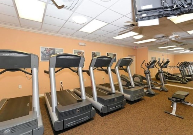 exercise room featuring crown molding and a paneled ceiling