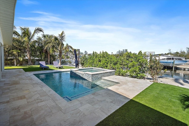 view of swimming pool with an in ground hot tub, a yard, and a patio