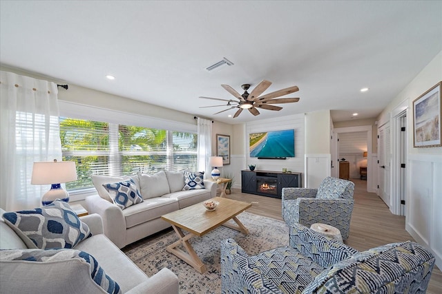 living room featuring hardwood / wood-style floors and ceiling fan