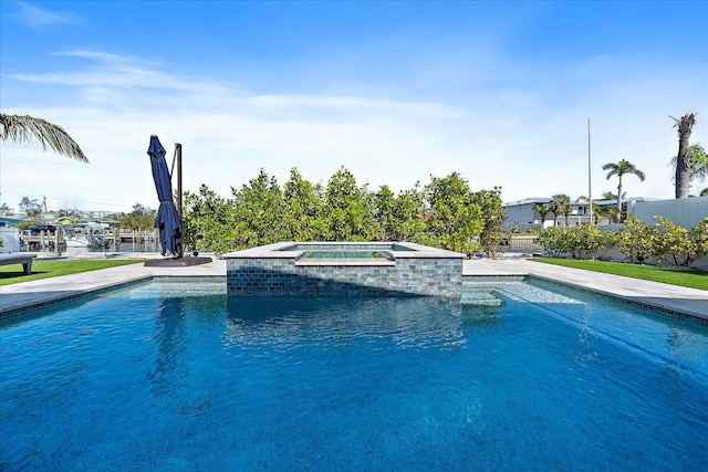 view of pool featuring an in ground hot tub