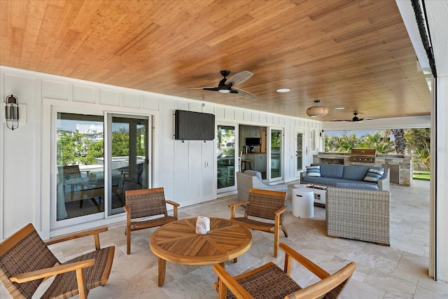 view of patio featuring an outdoor living space, an outdoor kitchen, a grill, and ceiling fan