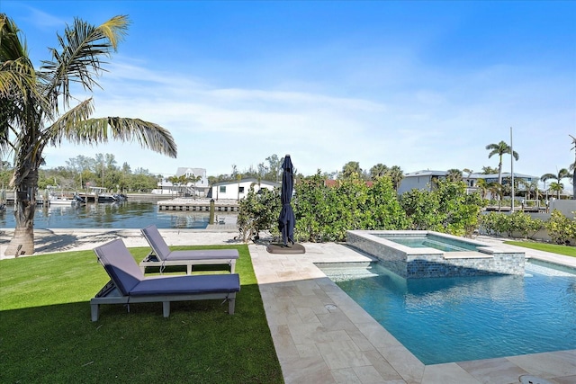 view of pool with a lawn, an in ground hot tub, and a water view