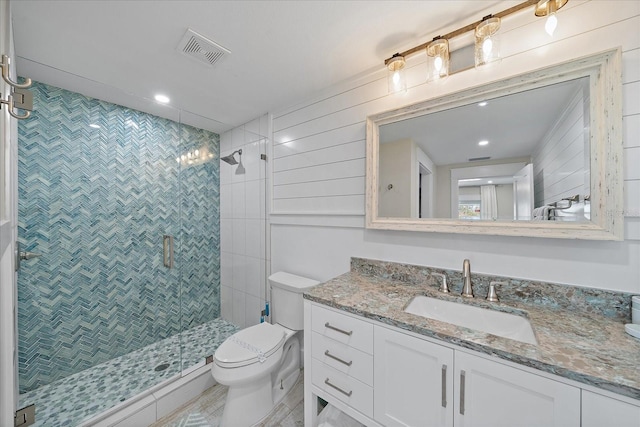 bathroom with vanity, an enclosed shower, and toilet