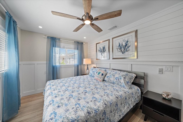 bedroom with ceiling fan and light hardwood / wood-style flooring