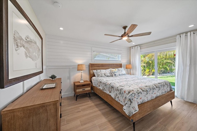 bedroom featuring access to exterior, ceiling fan, and light wood-type flooring