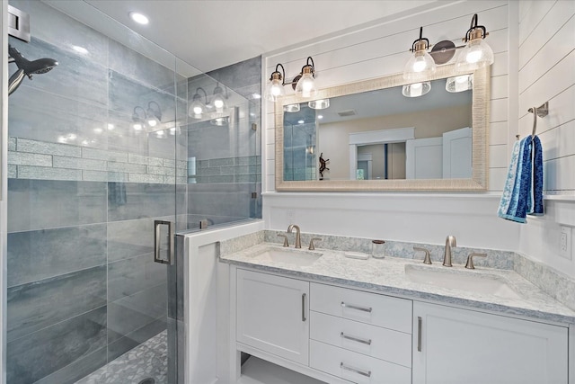 bathroom with walk in shower and vanity