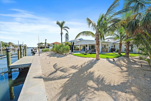 exterior space with a water view and a yard