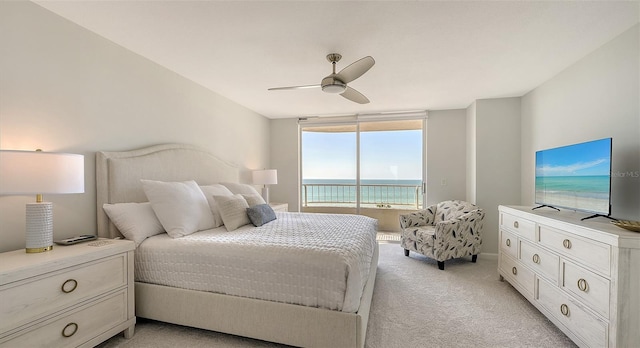 bedroom with ceiling fan, access to exterior, and light carpet