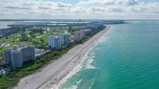 aerial view with a water view and a view of the beach