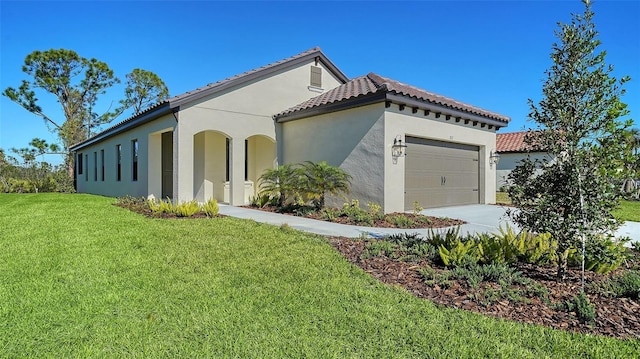 view of side of property featuring a garage and a lawn