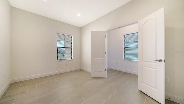 unfurnished bedroom featuring vaulted ceiling