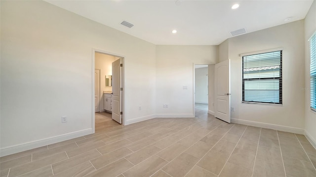 unfurnished bedroom with ensuite bathroom