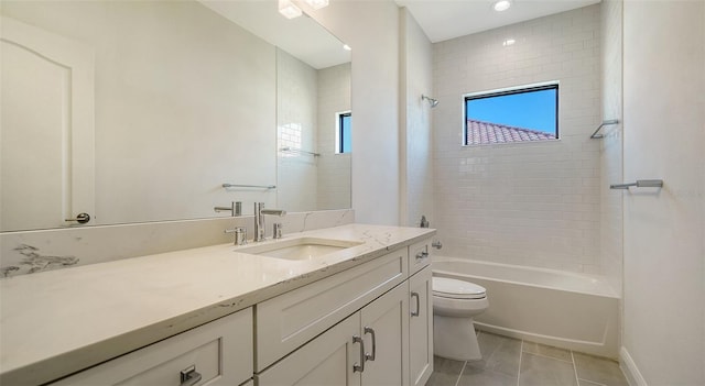 full bathroom featuring tile patterned flooring, vanity, tiled shower / bath combo, and toilet