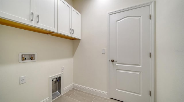 laundry room with cabinets, hookup for a washing machine, hookup for an electric dryer, and light tile patterned floors