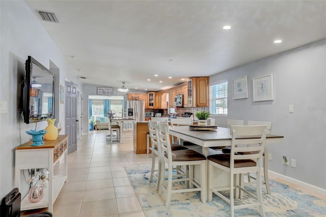 dining room featuring a healthy amount of sunlight, light tile patterned floors, visible vents, and recessed lighting