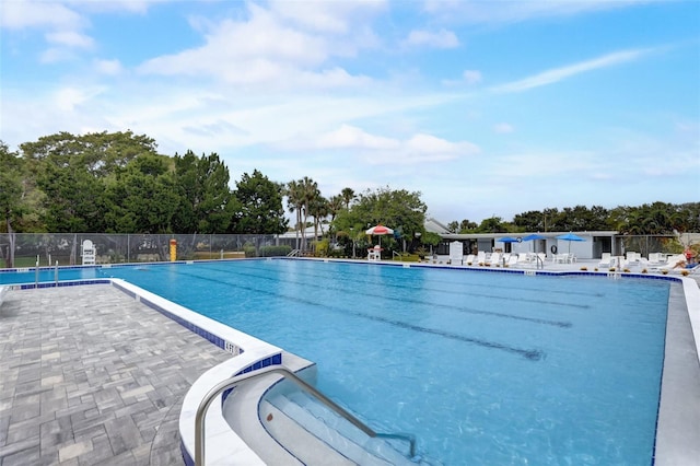 pool featuring a patio area and fence