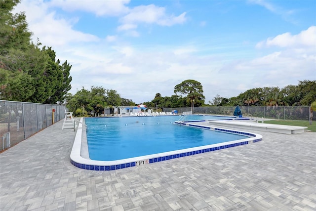 community pool featuring a patio and fence