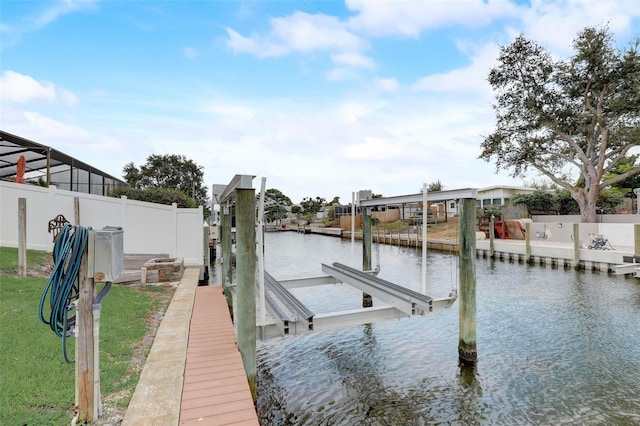 dock area featuring a water view, boat lift, and fence