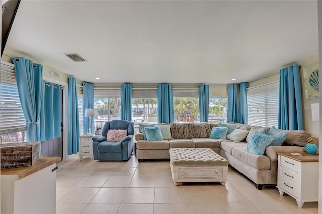 living room with light tile patterned floors, visible vents, and recessed lighting