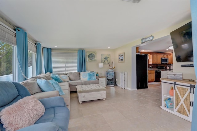 living room featuring recessed lighting, light tile patterned flooring, and baseboards