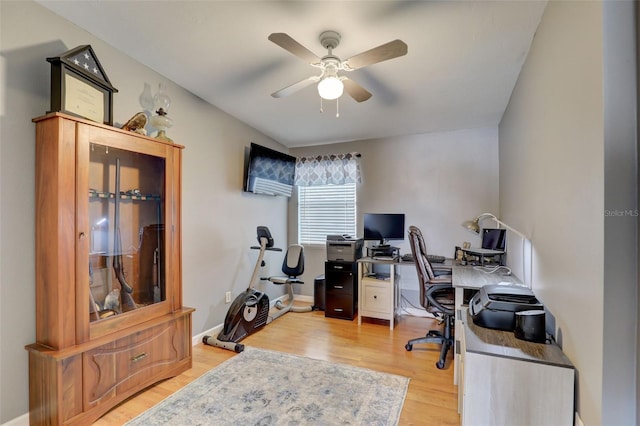 office space featuring light wood-type flooring, ceiling fan, and baseboards