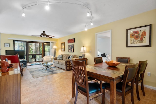 dining room with ceiling fan and light hardwood / wood-style floors