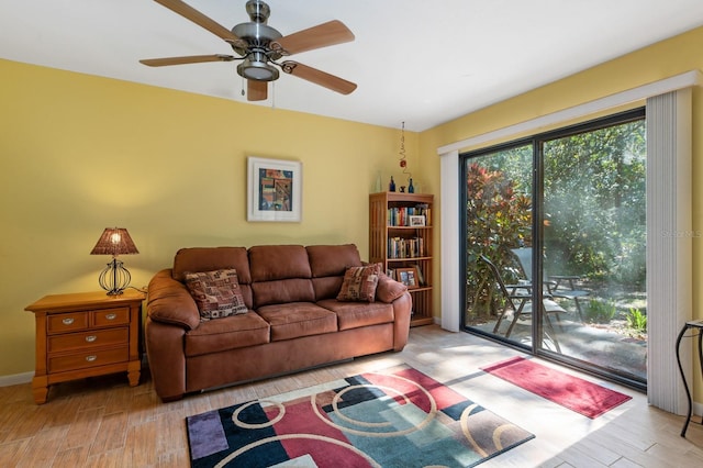 living room with ceiling fan and light wood-type flooring