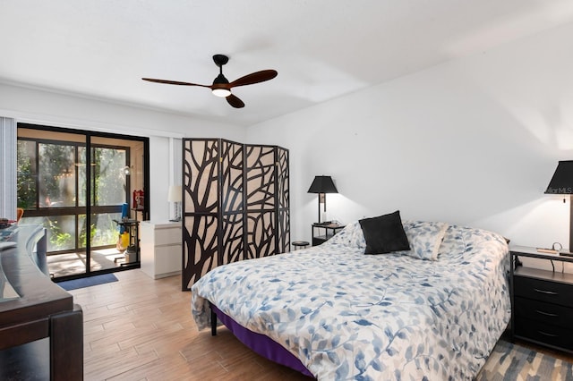 bedroom with ceiling fan, wood-type flooring, and access to outside