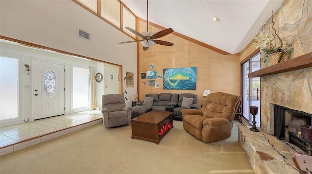 living room featuring visible vents, carpet, a textured ceiling, a fireplace, and high vaulted ceiling