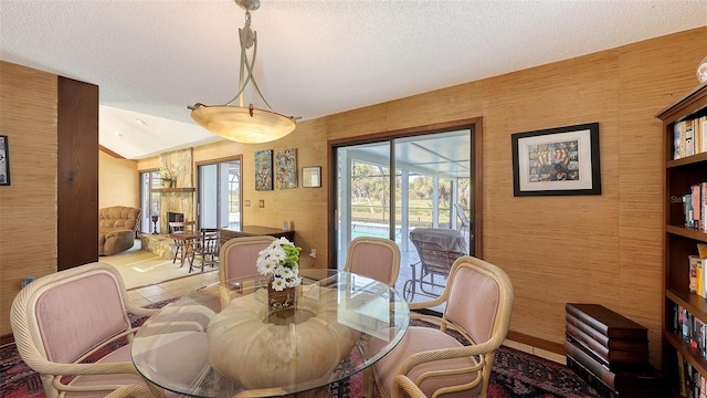 dining space with lofted ceiling and a textured ceiling